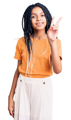 Canvas Print - Cute african american girl wearing casual clothes showing and pointing up with fingers number two while smiling confident and happy.