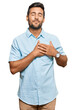 © Krakenimages.com - Handsome hispanic man wearing casual clothes smiling with hands on chest with closed eyes and grateful gesture on face. health concept.