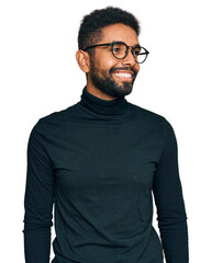 Poster - Young african american man wearing casual clothes looking away to side with smile on face, natural expression. laughing confident.