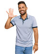 © Krakenimages.com - Handsome man with beard wearing casual clothes showing and pointing up with fingers number five while smiling confident and happy.
