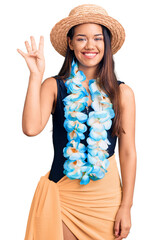 Canvas Print - Young beautiful latin girl wearing hawaiian lei and summer hat showing and pointing up with fingers number four while smiling confident and happy.