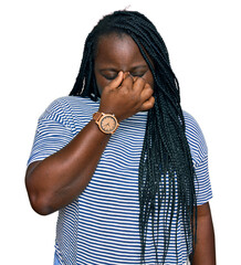 Canvas Print - Young black woman with braids wearing casual clothes tired rubbing nose and eyes feeling fatigue and headache. stress and frustration concept.