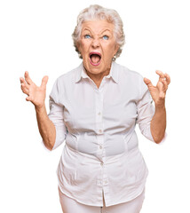 Wall Mural - Senior grey-haired woman wearing casual clothes crazy and mad shouting and yelling with aggressive expression and arms raised. frustration concept.