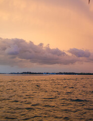 Wall Mural - sun setting over the gulf of mexico from the point of view of a viewer on a boat.