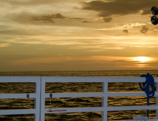 Wall Mural - sun setting over the gulf of mexico from the point of view of a viewer on a boat.