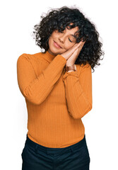 Poster - Young hispanic woman wearing casual clothes sleeping tired dreaming and posing with hands together while smiling with closed eyes.