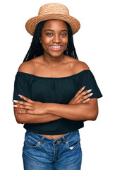 Poster - Young african american woman wearing summer hat happy face smiling with crossed arms looking at the camera. positive person.