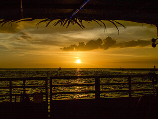 Wall Mural - sunset cruise views from the boat. other boats seen on the horizon as the sun is setting
