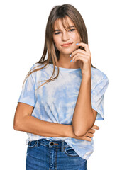 Wall Mural - Teenager caucasian girl wearing casual clothes serious face thinking about question with hand on chin, thoughtful about confusing idea