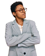 Canvas Print - Young african american woman wearing business clothes looking to the side with arms crossed convinced and confident