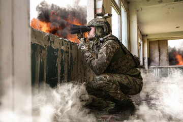 Wall Mural - Soldier in uniform with binoculars inside abandoned building during military operation