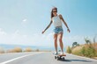 © Ben Kuang - Young woman skateboarding on an open road under a clear blue sky, enjoying a sunny day.