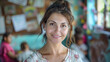 © tashechka - Portrait of a smiling woman in a vibrant, colorful classroom setting, creating a warm and inviting atmosphere.
