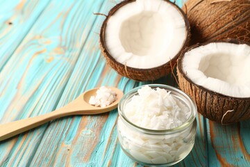 Poster - New coconut oil in glass and wooden spoon on wooden table