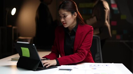 Wall Mural - Businesswoman working overtime in the office at night. Accountants are calculating budgets and planning finances. Accounting for income and expenses.