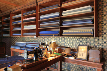 Nonsan-si, Chungcheongnam-do, South Korea - April 15, 2023: Interior of sewing machine with fabric cloth on the shelf in tailor shop of Sunshine Land
