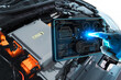 © BLKstudio - EV electric vehicle technology industry concept , futuristic virtual graphic touch user interface on screen with electric motor control unit of electric car on background