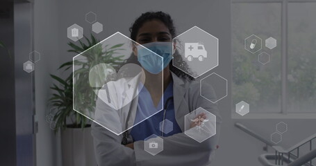 Poster - Image of digital icons data processing over biracial female doctor in face mask