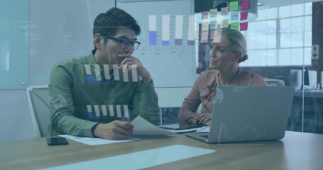 Poster - Image of graphs and globes over diverse coworkers discussing reports on laptop in office