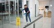 © peopleimages.com - Woman, cleaner and mopping floor in office for wellness, disinfect and protection from disease risk in building. Maintenance, female person and chemical liquid of pest control, health and hygiene