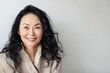 © LimeSky - Portrait of a happy middle aged Asian woman on a white background emphasizing her beauty and skincare routine