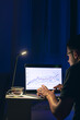 © puhimec - Man trading, browsing online stock investments at night.