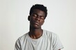 © LimeSky - Tired African American man in casual t shirt looks sleepy and exhausted with lazy eyes from a hangover standing on white background