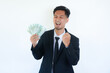 © AriaSandi - Young asian businessman holding money show fist up apreeciate happy about earn money