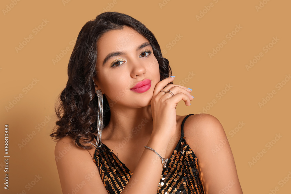 Beautiful young woman with stylish accessories on brown background