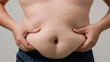 © ภาคภูมิ ปัจจังคะตา - Fat man with a big belly worries about his body. Fat man has excess fat on a white background. Concept of unhealthy body need to figure out. Men at risk for diabetes Belly fat. Obesity concept.