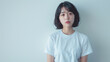© bephoto - 白い背景に立つ若い日本人女性