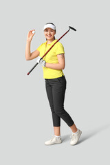 Poster - Beautiful female golfer on grey background