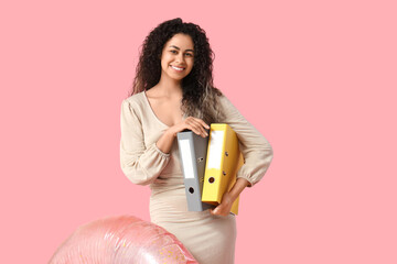 Poster - Happy female office worker with inflatable ring and folders on pink background. Summer vacation concept