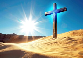 Jesus Christ's wooden cross stands large in a desert or sandy landscape, with rays of light shining from behind it against a clear blue sky. Religious and Spirituality concepts.