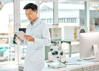 Poster - Science, Asian man and online with tablet in laboratory for monitor experiment, scientific analysis and medical research for study. Tech, internet and digital for trial results, breakthrough and cure