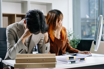 Furious two Asian businesspeople arguing strongly after making a mistake at work