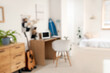 © Pixel-Shot - Blurred view of teenager's room with workplace, organizers and surfboard