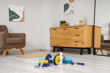 Poster - Sports equipment with water bottle in living room interior