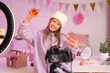 © Pixel-Shot - Teenage beauty blogger with bottles of perfume recording video in bedroom