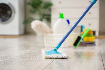 Poster - Mop on floor in laundry room, closeup