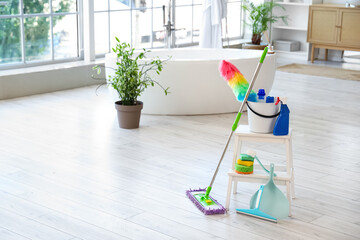 Wall Mural - Mop with bucket, different cleaning supplies and sponges on stepladder at home