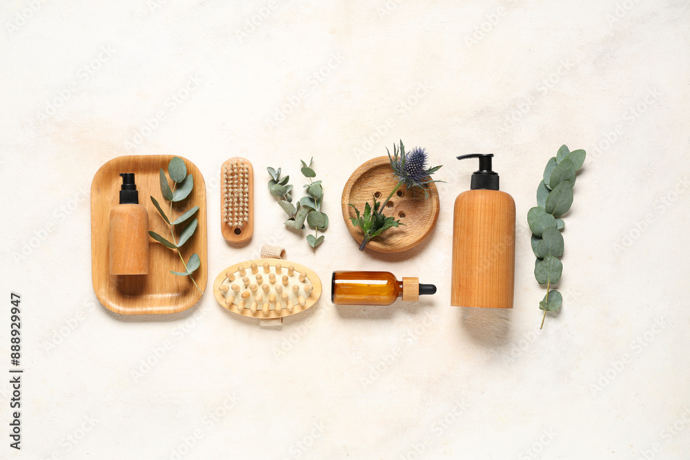 Composition with cosmetic products, spa accessories and eucalyptus branches on light background