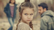 © Chatchanan - A young girl feeling torn between her arguing parents, tension in the air