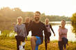 © Studio Romantic - Portrait of a happy group of people exercising and doing sports and workout in a city park. Outdoor fitness activities, highlighting the team commitment to staying active and healthy.