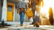 © Media Srock - A man in a yellow helmet is walking up to a house. He is carrying a toolbox and he is a handyman