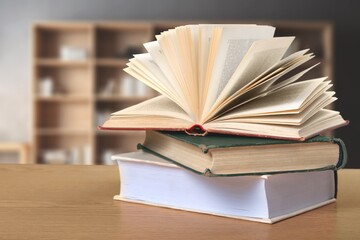Wall Mural - stack of books in library on wooden table