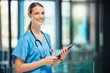 © peopleimages.com - Portrait, woman and nurse with tablet, clinic and confident in space, stethoscope and proud. Wellness, healthcare and medical research with smile, happy and ready for surgery in hospital and online