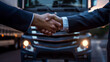 © Maksym - Against the backdrop of a sleek, modern truck, two businessmen shake hands, symbolizing a strategic alliance in the logistics industry.