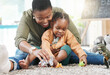 © Fanti/peopleimages.com - Black woman, teacher and girl with playing in kindergarten with toys for fun, education and child development. People, educator and happy on floor at school with support, care and help in day care