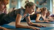 © Lakkhana - A group of people doing a Pilates mat class, focusing on core strength and controlled movements